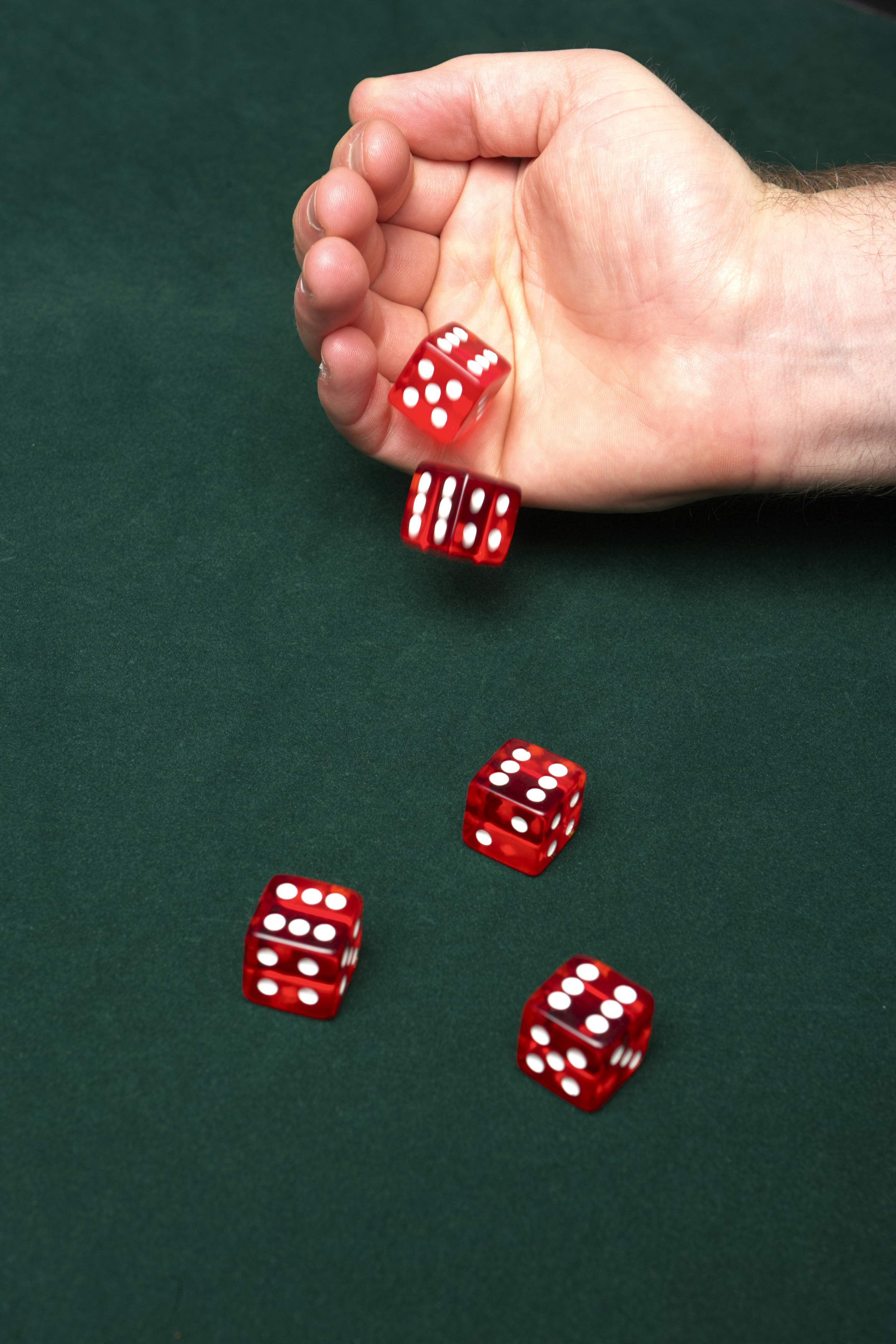 Man rolling 5 red dice